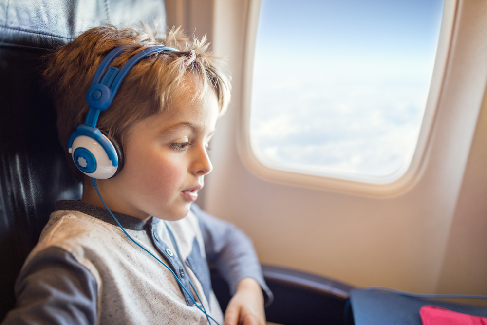 child getting entertained on a plane