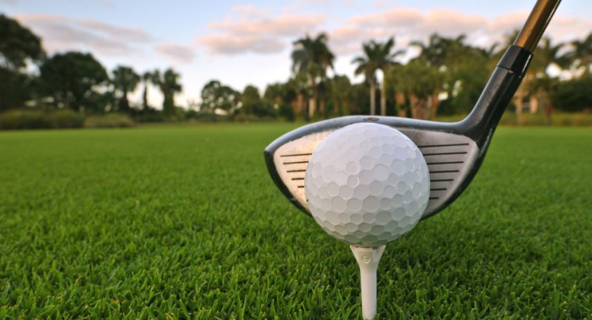 golf ball on tee on florida golf course at dawn