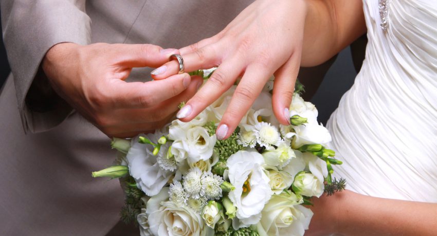 man putting womans ring on finger in las vegas