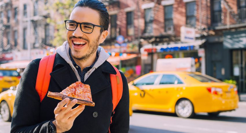 new yorker eating pizza