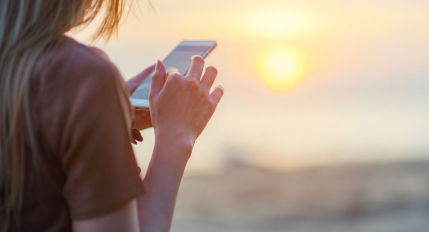 woman using mobile device for travel app