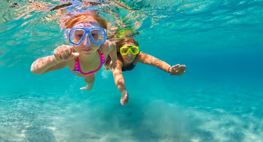 children snorkelling during school holidays