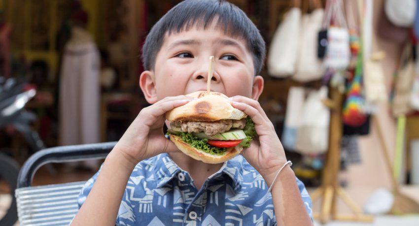 child eating burger